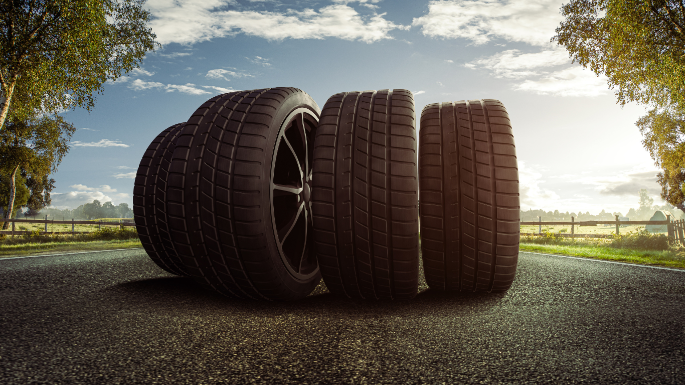Mobile Tire Services: four tire on rim, in the middle of the road.
