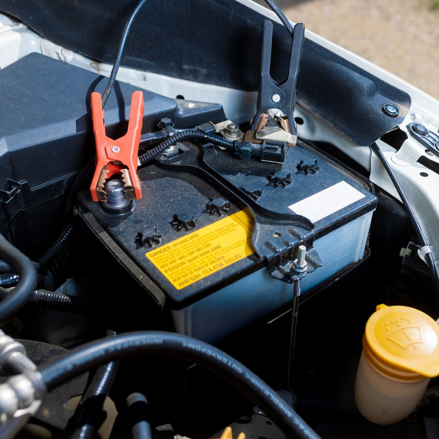 Battery Boost Service Near You: assisting a customer who's car battery is dead.