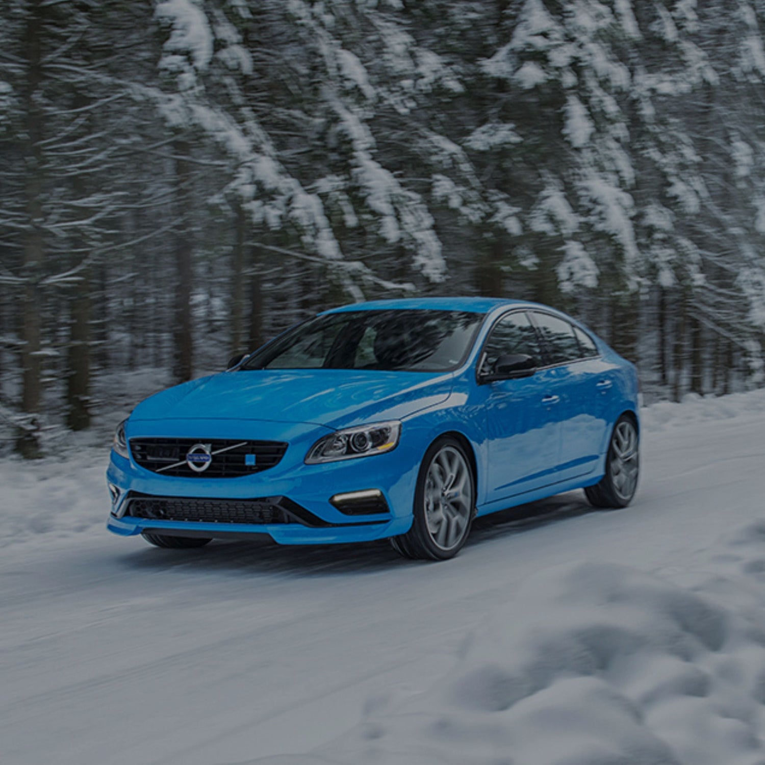 Seasonal tire change at home index, Polestar with snow tires driving on a snowy road.
